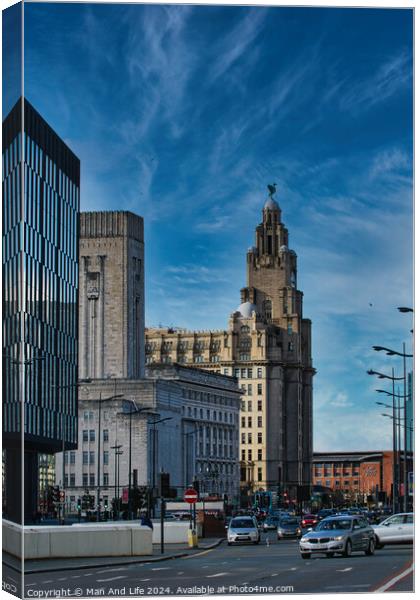Urban cityscape with historic architecture and modern buildings under a blue sky with wispy clouds in Liverpool, UK. Canvas Print by Man And Life