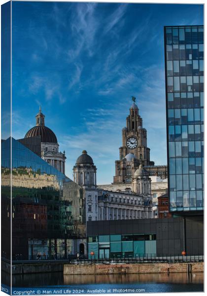 Contrast of old and new architecture with historic buildings and modern glass skyscraper against a blue sky with wispy clouds in Liverpool, UK. Canvas Print by Man And Life