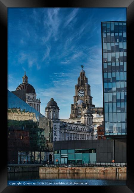 Contrast of old and new architecture with historic buildings and modern glass skyscraper against a blue sky with wispy clouds in Liverpool, UK. Framed Print by Man And Life