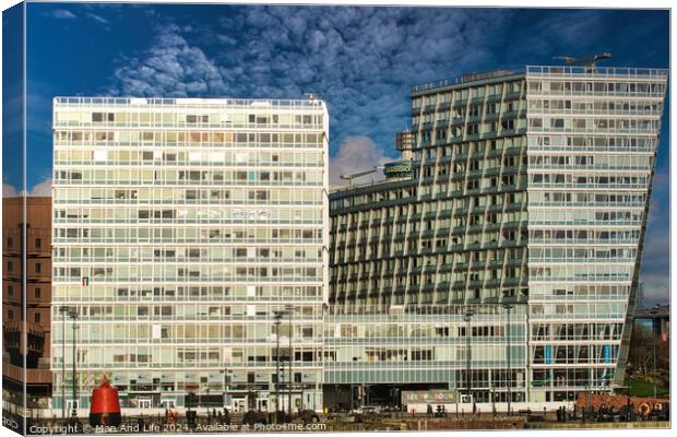 Modern office buildings with reflective glass facades against a blue sky with clouds in Liverpool, UK. Canvas Print by Man And Life