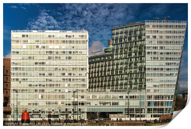 Modern office buildings with reflective glass facades against a blue sky with clouds in Liverpool, UK. Print by Man And Life