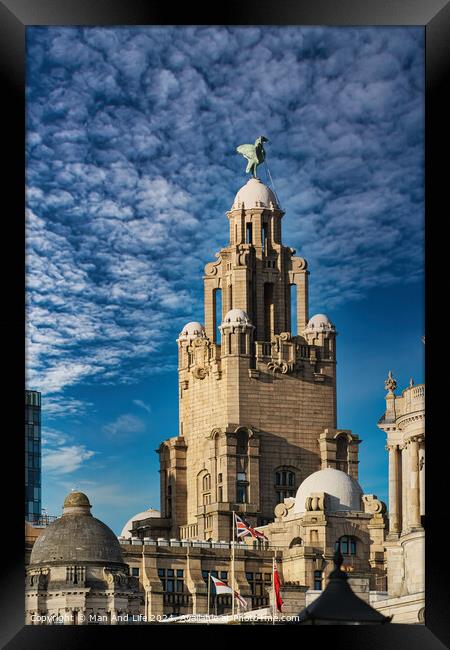Historic building with a statue on top under a blue sky with clouds in Liverpool, UK. Framed Print by Man And Life