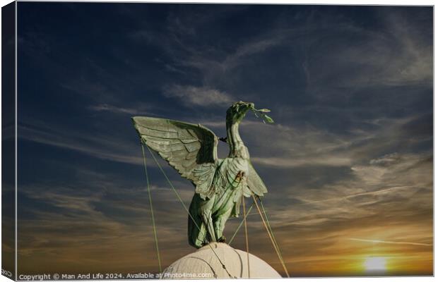 Bronze statue of an angel with outstretched wings against a vibrant sunset sky in Liverpool, UK. Canvas Print by Man And Life
