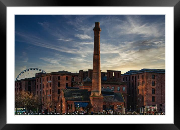 Historic red brick buildings with tall chimney against a dramatic sunset sky, with a Ferris wheel in the background in Liverpool, UK. Framed Mounted Print by Man And Life
