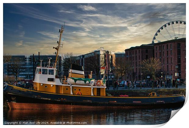 Tugboat in city harbor at sunset with ferris wheel and buildings in background in Liverpool, UK. Print by Man And Life