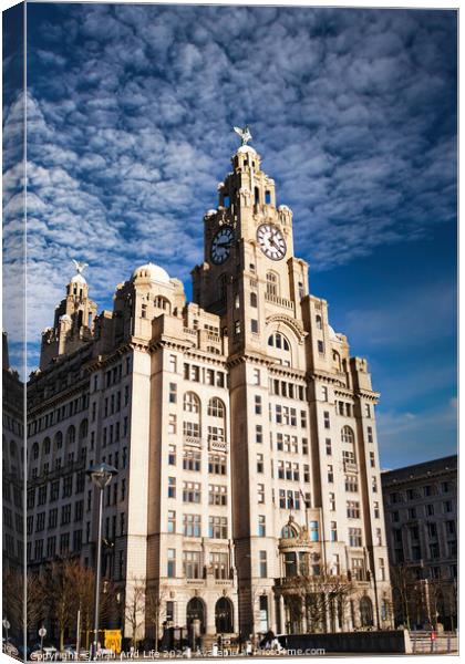 Historic clock tower building against a blue sky with clouds in Liverpool, UK. Canvas Print by Man And Life