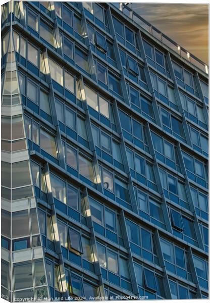 Modern office building facade with reflective glass windows against a twilight sky in Liverpool, UK. Canvas Print by Man And Life