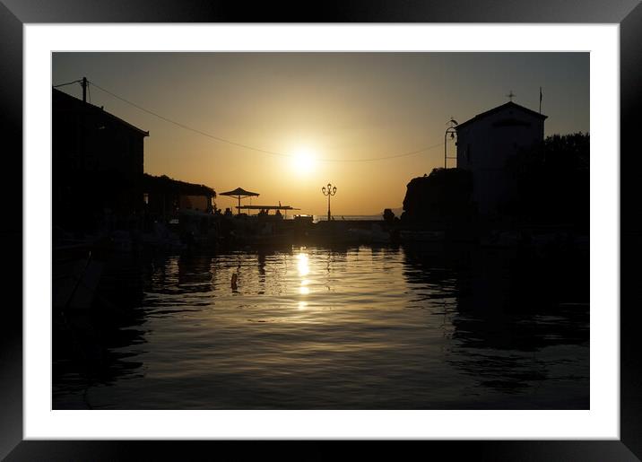 Sunset over the harbour pier Framed Mounted Print by Theo Spanellis