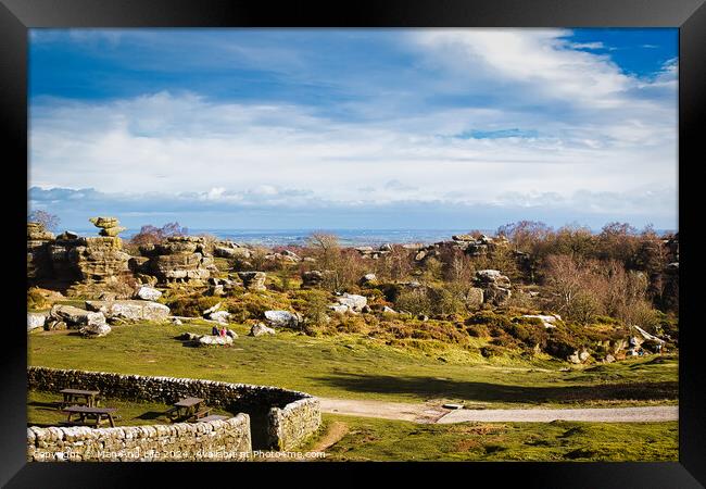 Scenic landscape with rocky formations, greenery, and a clear sky, ideal for travel and nature themes at Brimham Rocks, in North Yorkshire Framed Print by Man And Life