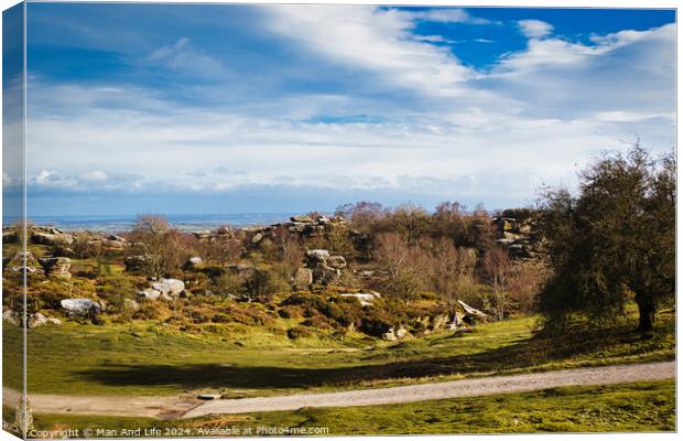 Idyllic rural landscape with lush green fields, scattered trees, and a clear blue sky with fluffy clouds at Brimham Rocks, in North Yorkshire Canvas Print by Man And Life