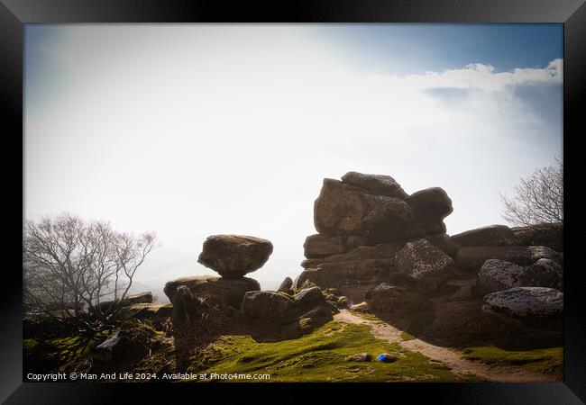 Misty landscape with balancing rock formations and a clear path under a bright sky at Brimham Rocks, in North Yorkshire Framed Print by Man And Life