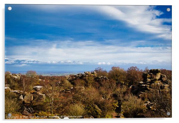 Scenic view of rocky terrain with lush greenery under a blue sky with fluffy clouds, overlooking a distant body of water at Brimham Rocks, in North Yorkshire Acrylic by Man And Life