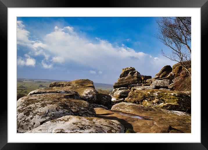 Scenic view of rugged rocks against a blue sky with fluffy clouds, highlighting the natural beauty of a mountainous landscape at Brimham Rocks, in North Yorkshire Framed Mounted Print by Man And Life