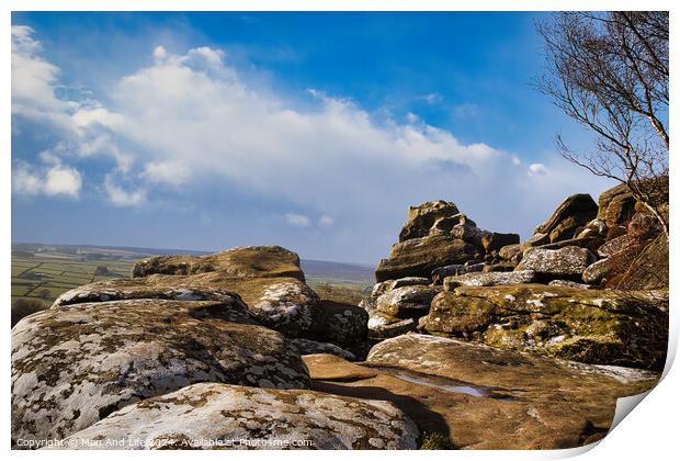 Scenic view of rugged rocks against a blue sky with fluffy clouds, highlighting the natural beauty of a mountainous landscape at Brimham Rocks, in North Yorkshire Print by Man And Life