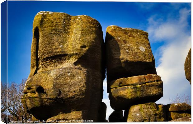 Majestic rock formations against a blue sky with clouds, showcasing natural erosion and geological textures at Brimham Rocks, in North Yorkshire Canvas Print by Man And Life