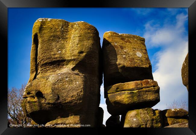Majestic rock formations against a blue sky with clouds, showcasing natural erosion and geological textures at Brimham Rocks, in North Yorkshire Framed Print by Man And Life
