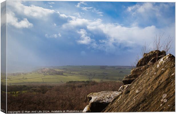 Scenic view from a rocky outcrop overlooking a lush valley under a dramatic cloudy sky at Brimham Rocks, in North Yorkshire Canvas Print by Man And Life