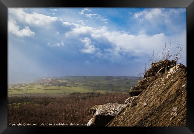 Scenic view from a rocky outcrop overlooking a lush valley under a dramatic cloudy sky at Brimham Rocks, in North Yorkshire Framed Print by Man And Life