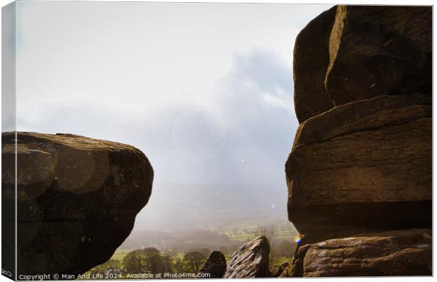 Scenic view of a landscape through rock formations under a cloudy sky at Brimham Rocks, in North Yorkshire Canvas Print by Man And Life