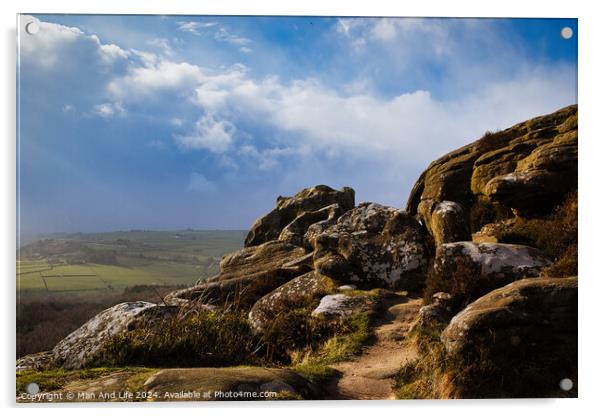 Majestic rocky landscape with sunlit grass under a blue sky with clouds at Brimham Rocks, in North Yorkshire Acrylic by Man And Life