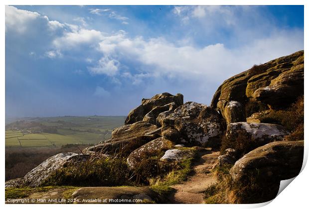 Majestic rocky landscape with sunlit grass under a blue sky with clouds at Brimham Rocks, in North Yorkshire Print by Man And Life