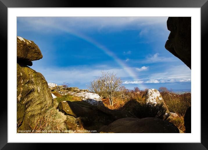 Scenic landscape with a rainbow over a solitary tree, framed by rocky outcrops under a blue sky with clouds at Brimham Rocks, in North Yorkshire Framed Mounted Print by Man And Life