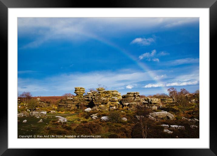 Vibrant rainbow over a rocky landscape with scattered boulders and lush greenery under a blue sky with clouds at Brimham Rocks, in North Yorkshire Framed Mounted Print by Man And Life