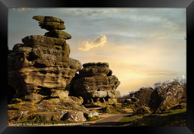 Scenic view of unique rock formations under a golden sunset sky with lush greenery in the foreground at Brimham Rocks, in North Yorkshire Framed Print by Man And Life