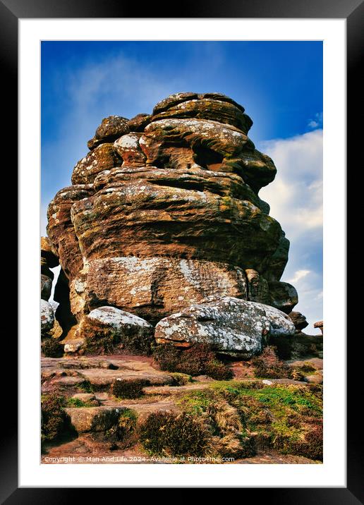 Majestic rock formation under blue sky with clouds, showcasing natural erosion and geological layers at Brimham Rocks, in North Yorkshire Framed Mounted Print by Man And Life