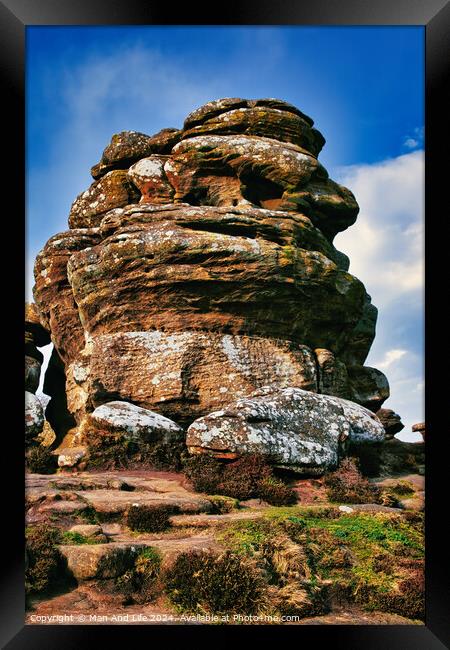 Majestic rock formation under blue sky with clouds, showcasing natural erosion and geological layers at Brimham Rocks, in North Yorkshire Framed Print by Man And Life