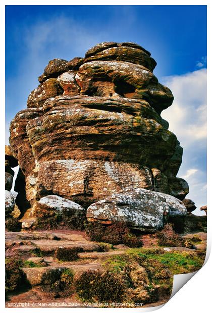 Majestic rock formation under blue sky with clouds, showcasing natural erosion and geological layers at Brimham Rocks, in North Yorkshire Print by Man And Life