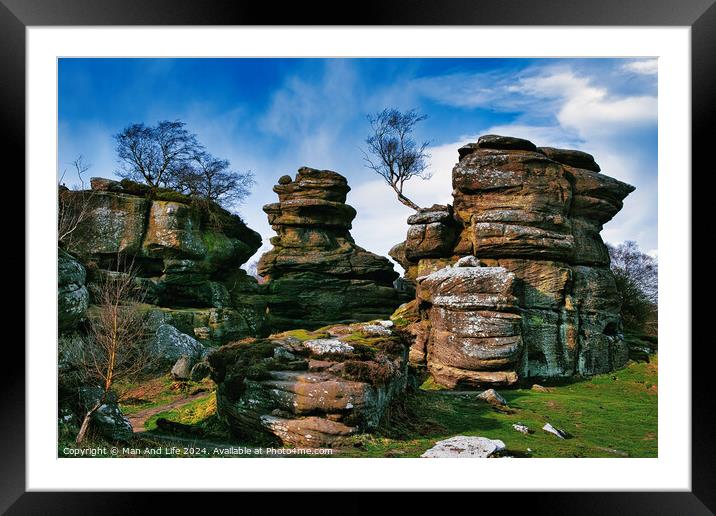 Scenic view of weathered rock formations with a solitary tree against a blue sky with clouds at Brimham Rocks, in North Yorkshire Framed Mounted Print by Man And Life