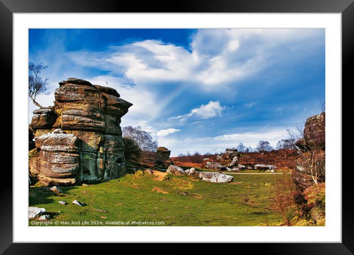 Scenic view of rock formations and lush greenery under a blue sky with wispy clouds at Brimham Rocks, in North Yorkshire Framed Mounted Print by Man And Life