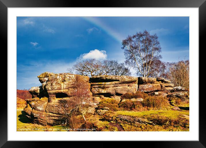 Scenic view of a rocky outcrop with a lone tree against a blue sky with a faint rainbow in the countryside at Brimham Rocks, in North Yorkshire Framed Mounted Print by Man And Life