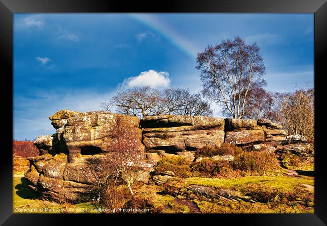 Scenic view of a rocky outcrop with a lone tree against a blue sky with a faint rainbow in the countryside at Brimham Rocks, in North Yorkshire Framed Print by Man And Life