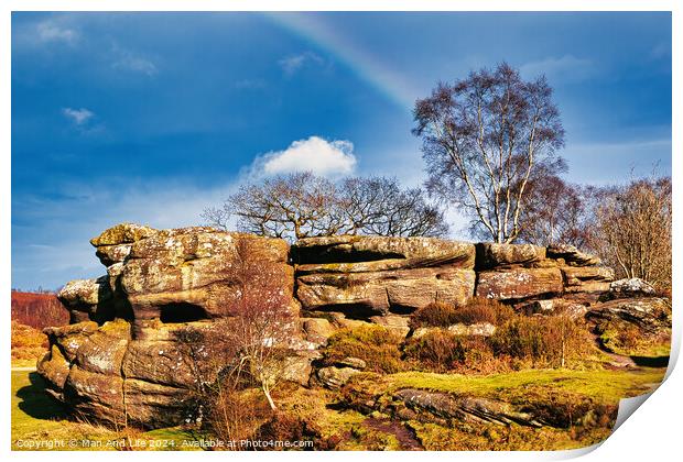 Scenic view of a rocky outcrop with a lone tree against a blue sky with a faint rainbow in the countryside at Brimham Rocks, in North Yorkshire Print by Man And Life