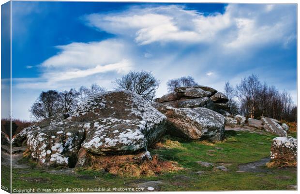 Rugged landscape with moss-covered rocks under a cloudy sky at Brimham Rocks, in North Yorkshire Canvas Print by Man And Life