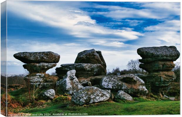 Scenic view of unique rock formations under a blue sky with clouds at Brimham Rocks, in North Yorkshire Canvas Print by Man And Life