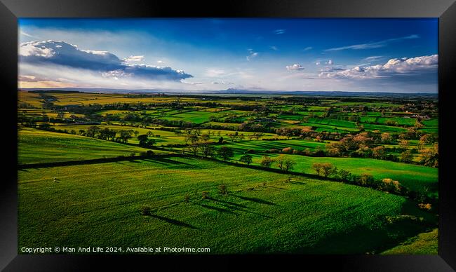 Aerial view of lush green countryside with fields and shadows cast by clouds, showcasing rural beauty in North Yorkshire. Framed Print by Man And Life