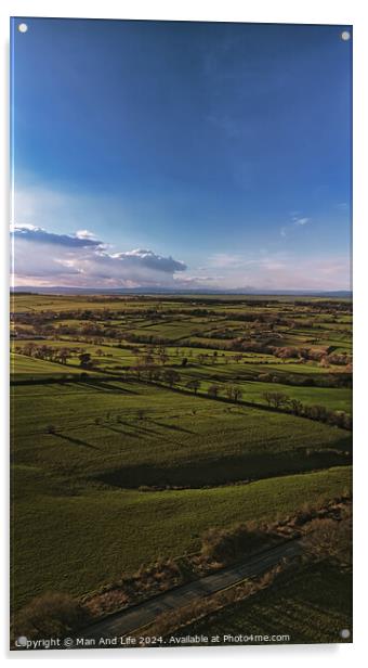 Scenic aerial view of lush green fields under a dramatic sky at dusk, showcasing the beauty of rural landscapes in North Yorkshire. Acrylic by Man And Life