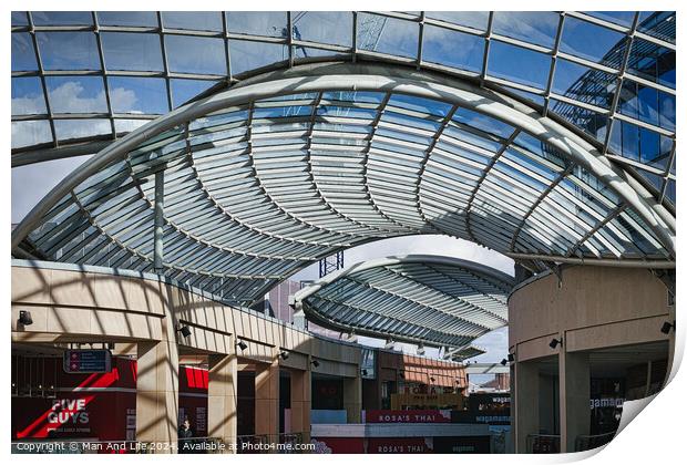 Modern glass ceiling architecture at a shopping mall with blue sky and clouds visible through the transparent structure in Leeds, UK. Print by Man And Life