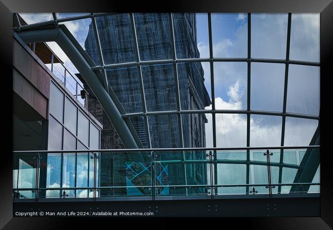 Modern glass building facade with reflections of clouds, showcasing contemporary architecture and design in Leeds, UK. Framed Print by Man And Life