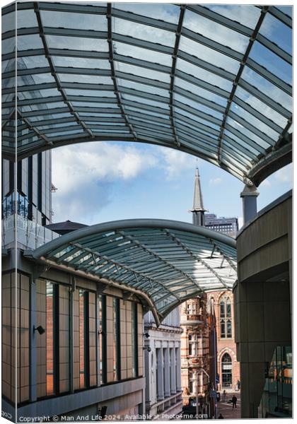 Modern glass canopy over a pedestrian walkway with historic architecture in the background on a sunny day in Leeds, UK. Canvas Print by Man And Life