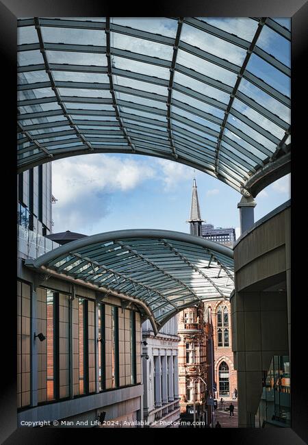 Modern glass canopy over a pedestrian walkway with historic architecture in the background on a sunny day in Leeds, UK. Framed Print by Man And Life