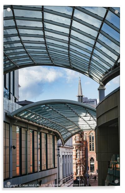 Modern glass canopy over a pedestrian walkway with historic architecture in the background on a sunny day in Leeds, UK. Acrylic by Man And Life