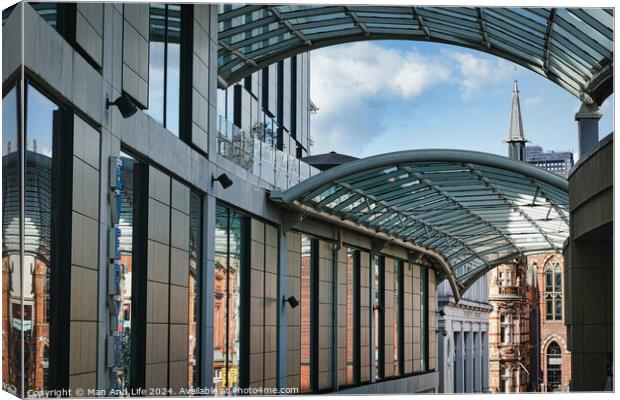 Modern glass-covered walkway with urban architecture and blue sky in the background in Leeds, UK. Canvas Print by Man And Life