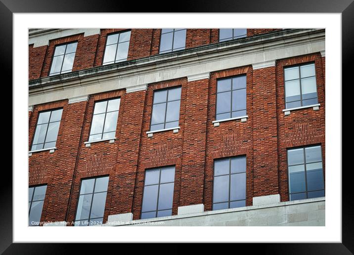 Facade of a brick building with symmetrical windows reflecting the sky, architectural background in Leeds, UK. Framed Mounted Print by Man And Life