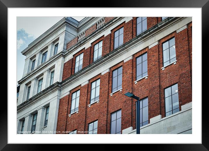 Classic brick building facade with large windows and decorative cornices, under a clear sky in Leeds, UK. Framed Mounted Print by Man And Life