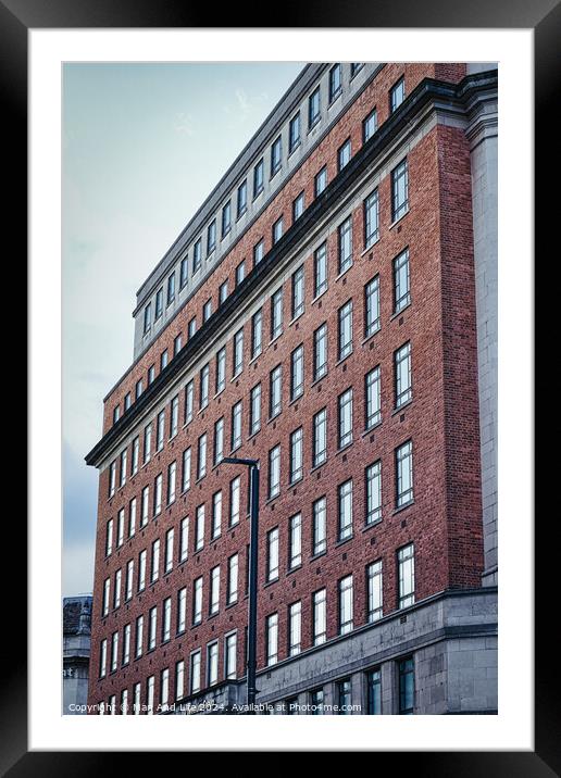 Facade of a red brick office building with multiple windows under a cloudy sky, showcasing urban architecture in Leeds, UK. Framed Mounted Print by Man And Life