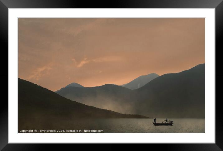 Sunset over the mountains with a silhouetted fishing boat Framed Mounted Print by Terry Brooks